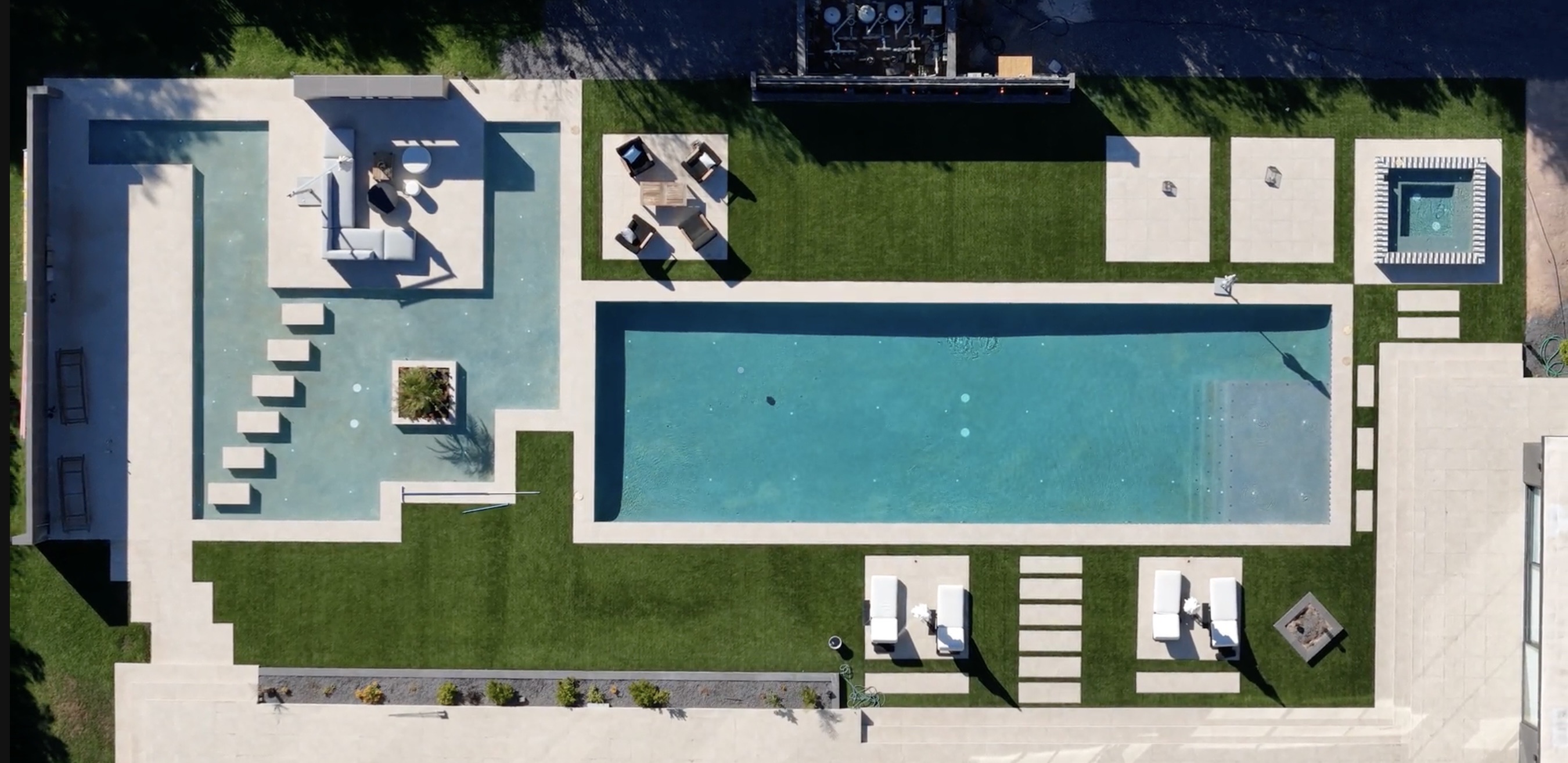 Aerial view of a lap pool with raised mosaic spa